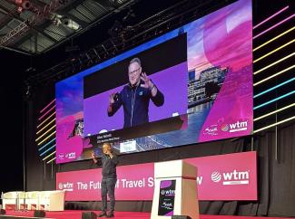 A man on a stage delivering a speech