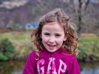 A young girl smiling