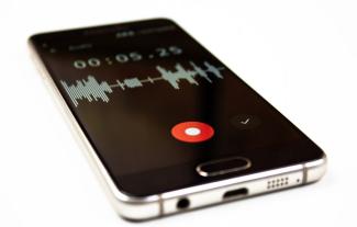 A smartphone, displaying soundwaves on a recording app