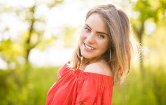 A woman in an outdoor setting smiling