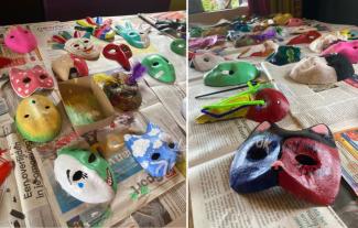 Lots of brightly painted masks on a table