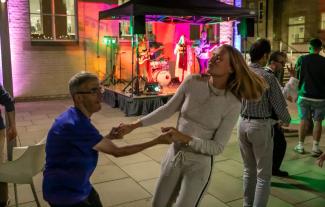 A man and a woman dancing, hand in hand