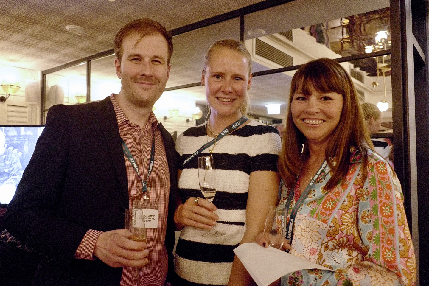 A man and two women looking at the camera and smiling