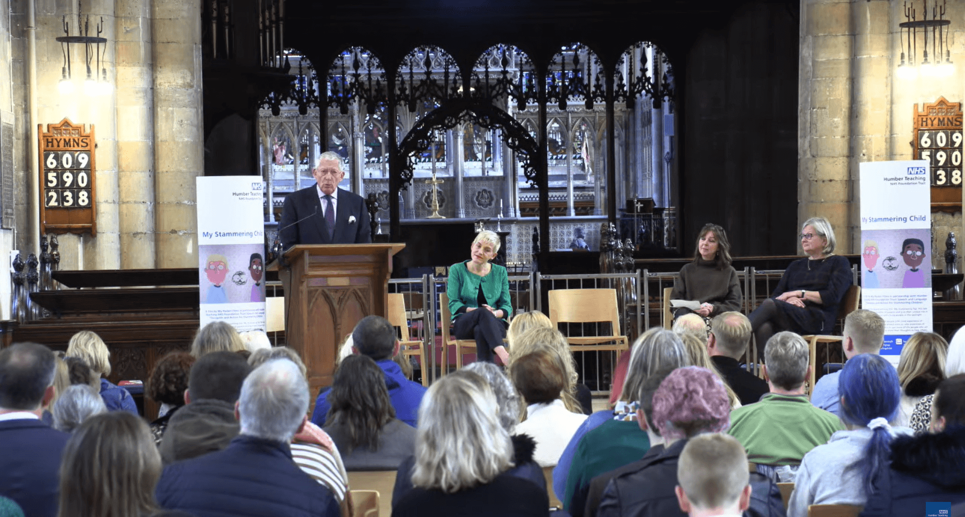 A man speaking to an audience in a church