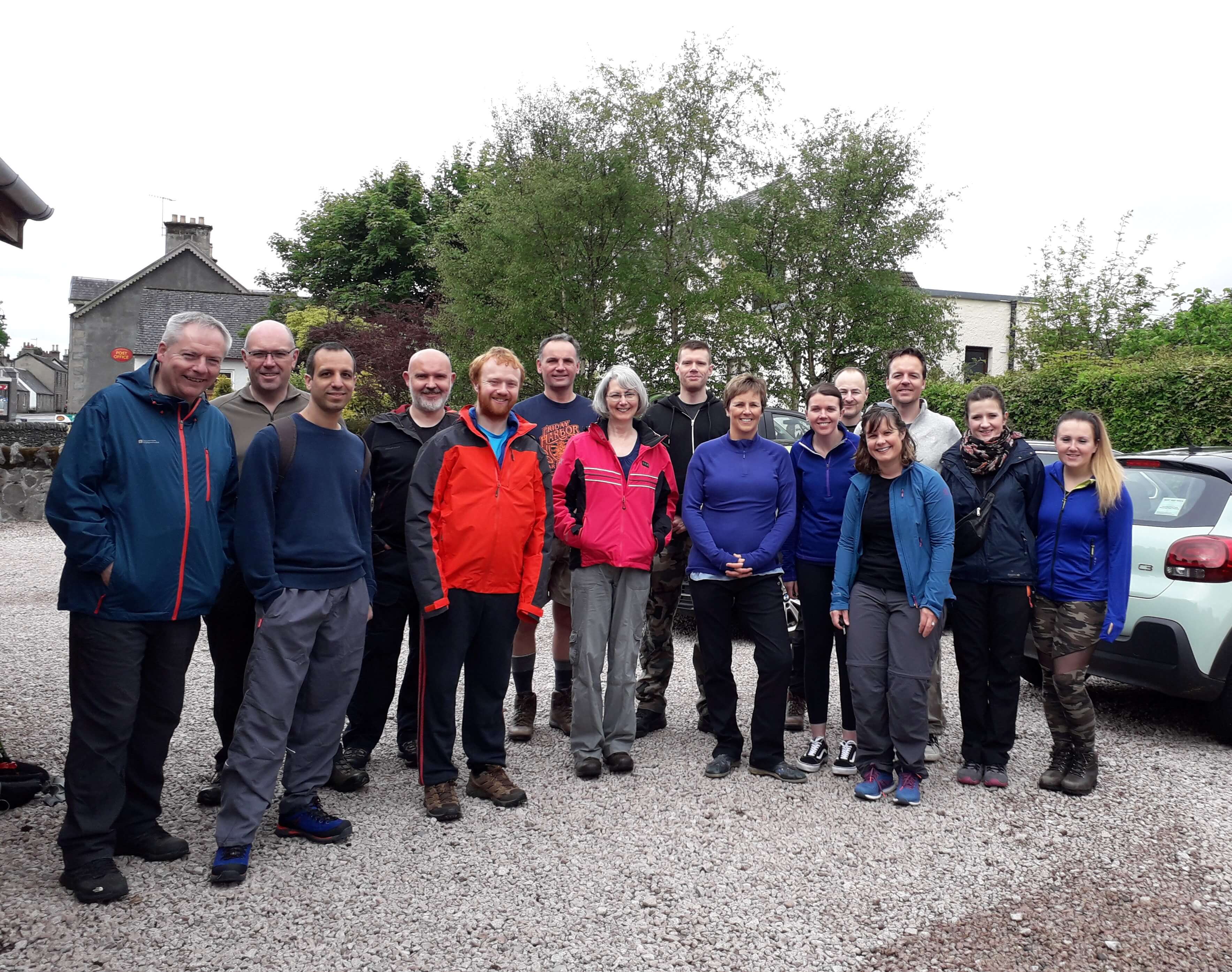 A group of hikers posing for the camera before walking