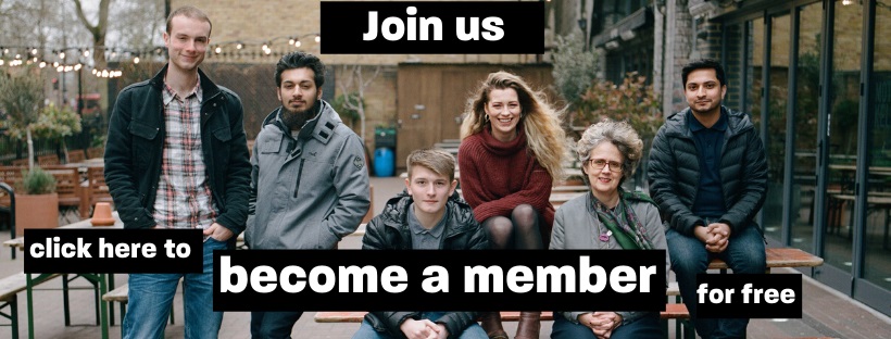 A group of people on a bench looking at the camera