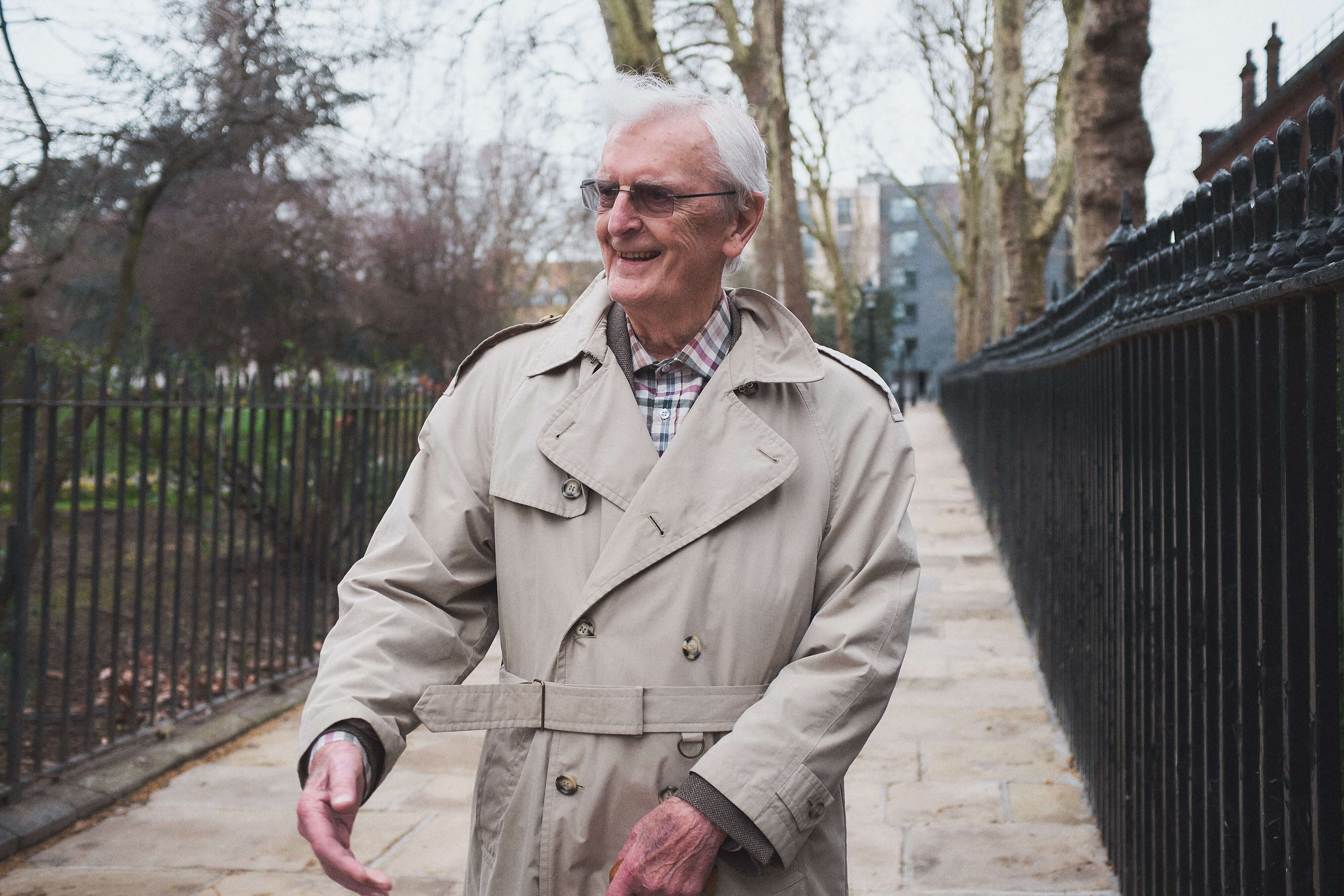 An elderly man looking to his right and smiling